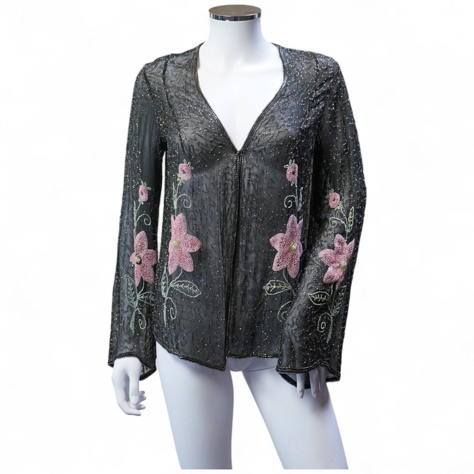 A 1930’s, multi coloured floral hand beaded evening jacket, the beading worked on black georgette. Possibly French, label on the inside of the neck 48. 64cm long. Condition - beading and georgette appear in good conditio
